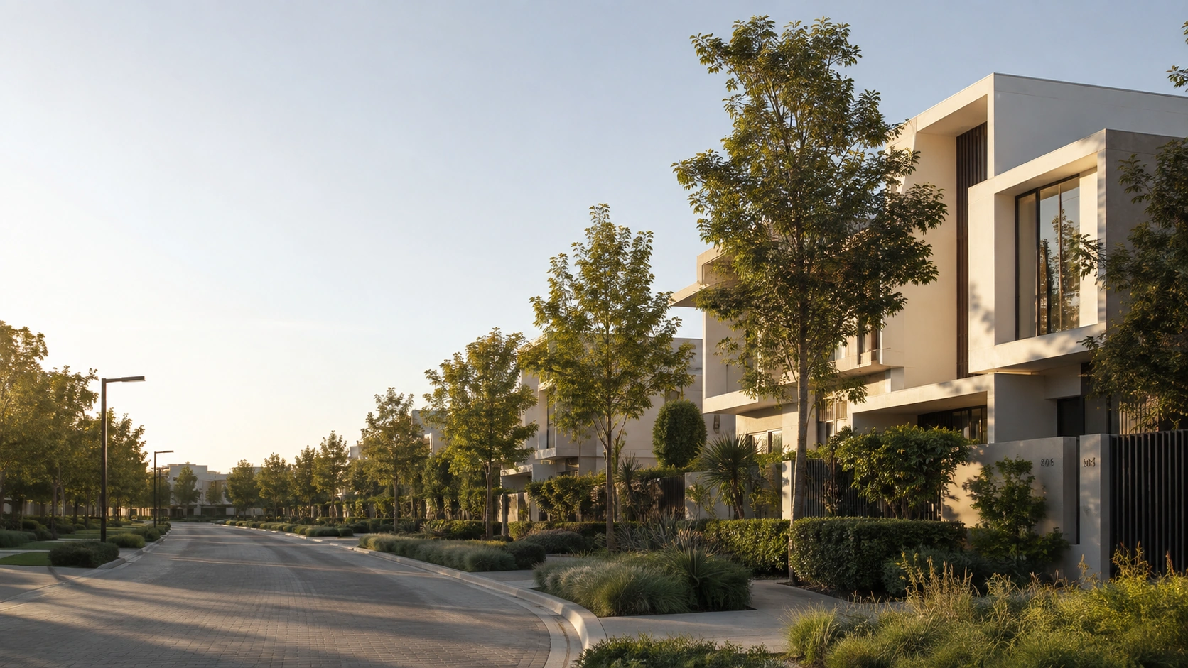 Premium contemporary Dubai villa community streetscape at early evening with mature landscaping